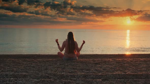 Woman Meditating on the Seashore