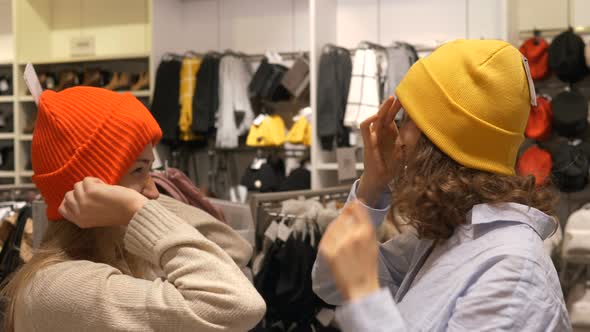 Women Try on Hats Enjoying Leisure Time in City Mall Store