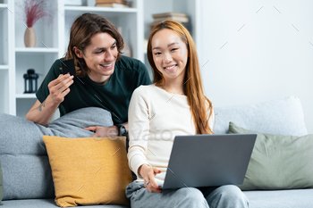Couple Shopping Online With Credit Card At Home