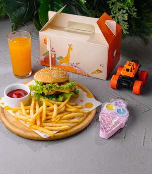 Kid's meal with toy and juice on table