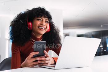 Ethnic female with laptop and phone