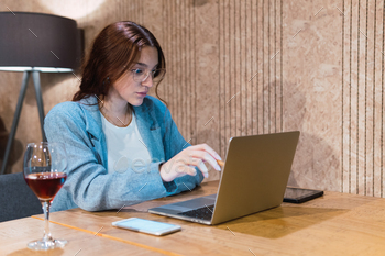 Businesswoman using laptop in restaurant