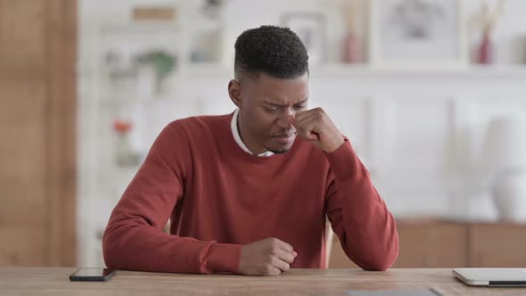 Upset African Man Feeling Worried While Sitting in Office