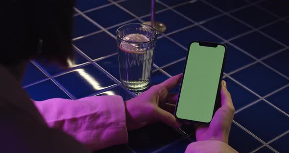 Close Up of Woman Holding Cell Phone with Chroma Key Screen