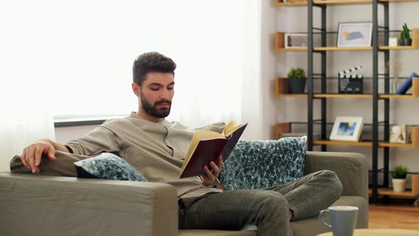 Man Reading Book at Home