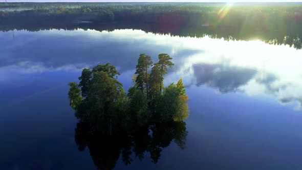 Beautiful view of scenic lake, island and forest in russian nature. Drone Shot