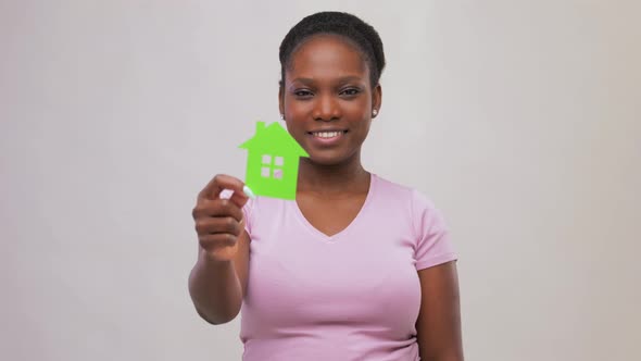 Smiling African American Woman Holding Green House