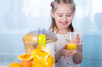 Happy kid making orange juice