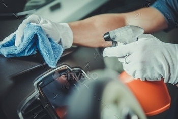 Worker Cleaning the Car Dashboard