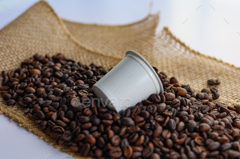 coffee beans in a coffee can surrounded by jute of burlock