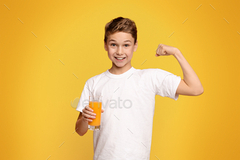 Young Boy Holding Glass of Orange Juice