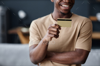 Joyful Man Holding Credit Card