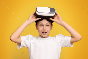 Young Boy Holding Device on Head