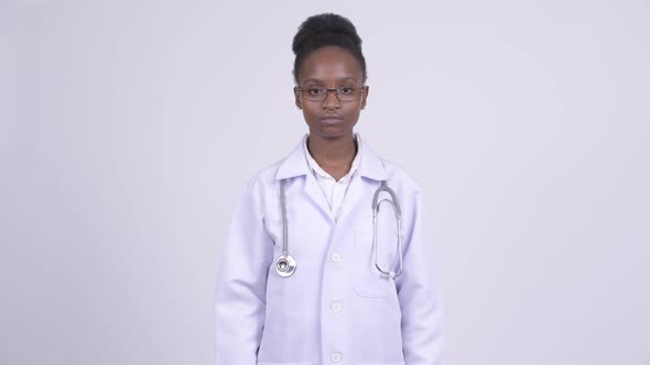 Young African Woman Doctor Covering Eyes As Three Wise Monkeys Concept