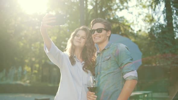 Happy Couple Taking Photos And Having Fun In Nature On Weekend