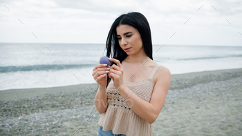 Woman Holding A Stress Ball At The Beach