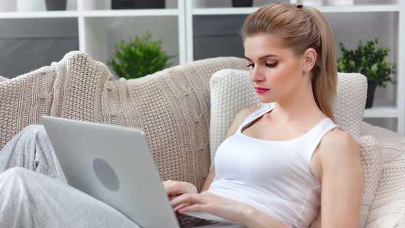 Adorable Busy Young Smiling Girl Using Laptop Typing Text on Keyboard Having Positive Emotion