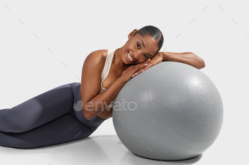 Woman Laying on Top of a Gym Ball