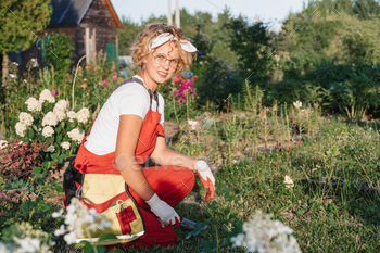 The gardener moves the soil with a shovel, prepares it for planting. Gardening and floriculture.