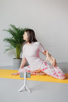 Yoga sports online at home. woman does sports and meditations at home, stretching