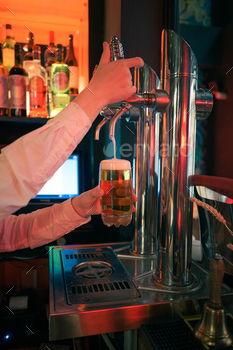 Bartender pouring beer into glass