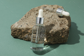 Cosmetic oil in a transparent bottle with a stone