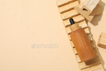 Cosmetic oil in a wooden bottle with a brick