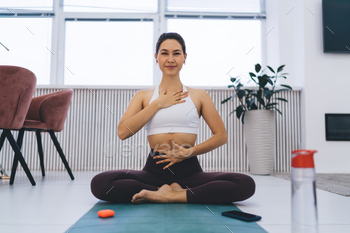 Smiling woman performing yoga exercise
