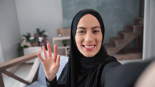 Close Up Face of Muslim Woman in Black Hijab Talking Online Videoconference Call Smiling POV Shot