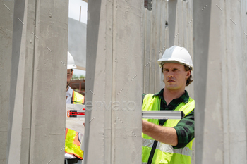 Engineers in a yellow vest is working on a construction site