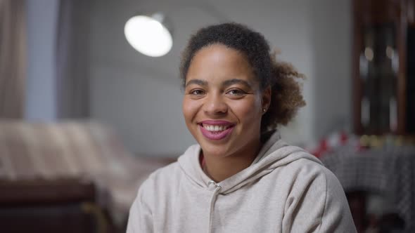 Portrait of Happy Charming African American Woman with Brown Eyes Looking at Camera Smiling