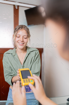 Woman using credit card to pay in a clinic
