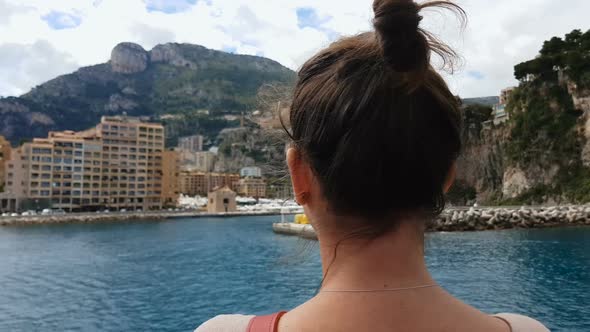 Woman Observing Hotels at Coastline Affordable Accommodation for Tourists