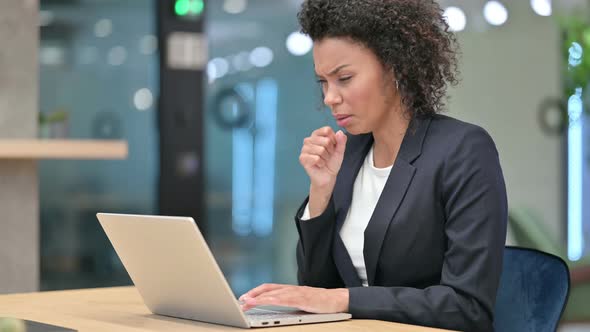 Sick African Businesswoman with Laptop Coughing at Work 