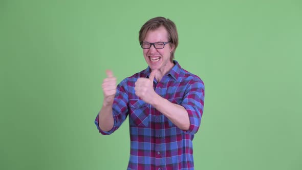 Happy Young Handsome Hipster Man Giving Thumbs Up and Looking Excited