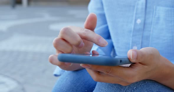 Woman touch on mobile phone in city