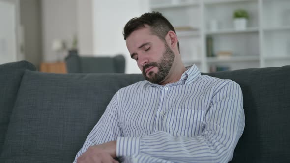 Tired Young Man Taking Nap on Sofa 