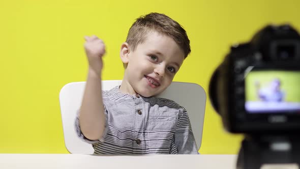 Child blogger videotapes his vlog at home. Boy recording his video blog