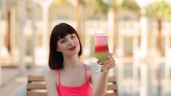 Summer Holiday Fashion Concept  Tanning Woman Wearing Pink Bikini Swimsuit with Cocktail Glass