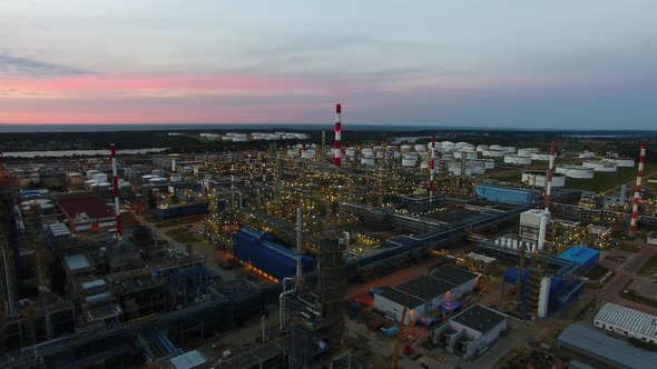 Aerial view of the petrochemical oil refinery plant shines at night