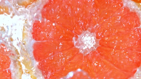 Super Slow Motion Shot of Splashing Water to Grapefruit Slices at 1000Fps