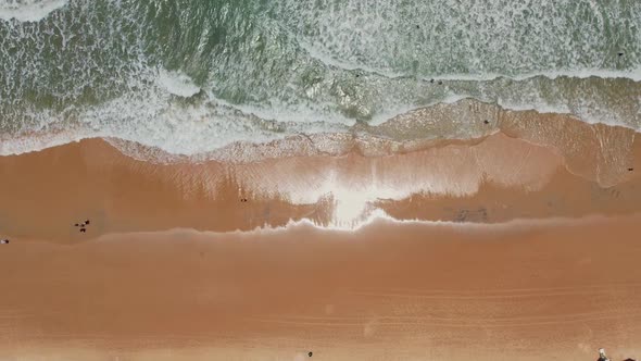 Topdown upwards waves crashing at beach shore, Natal, Brazilian coastline