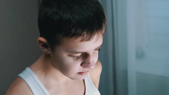 Portrait of a Guilty Talking Child Looking Down at Floor with Downcast Eyes