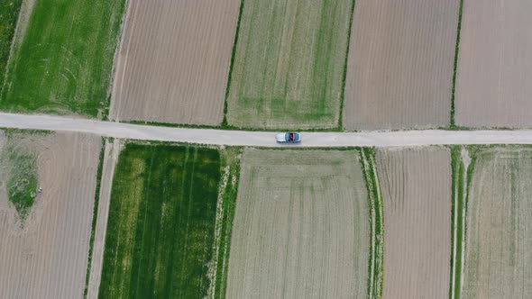 Car Parked Between Fields