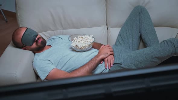 Caucasian Male Falling Asleep While Watching Movie Show Sitting on Couch