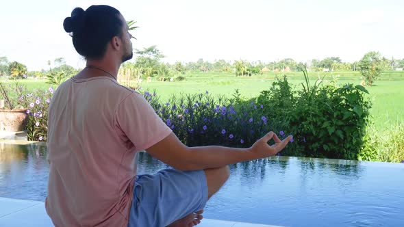 Man Meditating Yoga in Exotic Garden