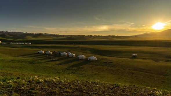 Landscape with Yurts and Mountains at Sunset