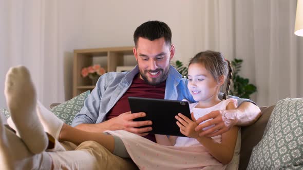 Father and Daughter with Tablet Pc at Home 