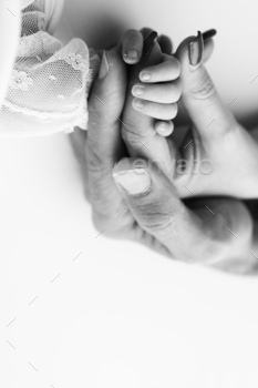 Close-up little hand of child and palm of mother father. Black and white photo.
