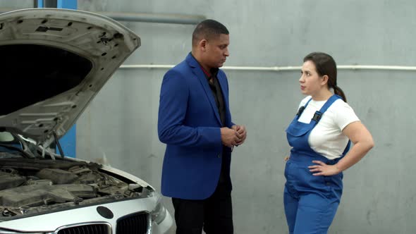 Man Talks with Mechanic and Gives Keys of Car, Slow Motion